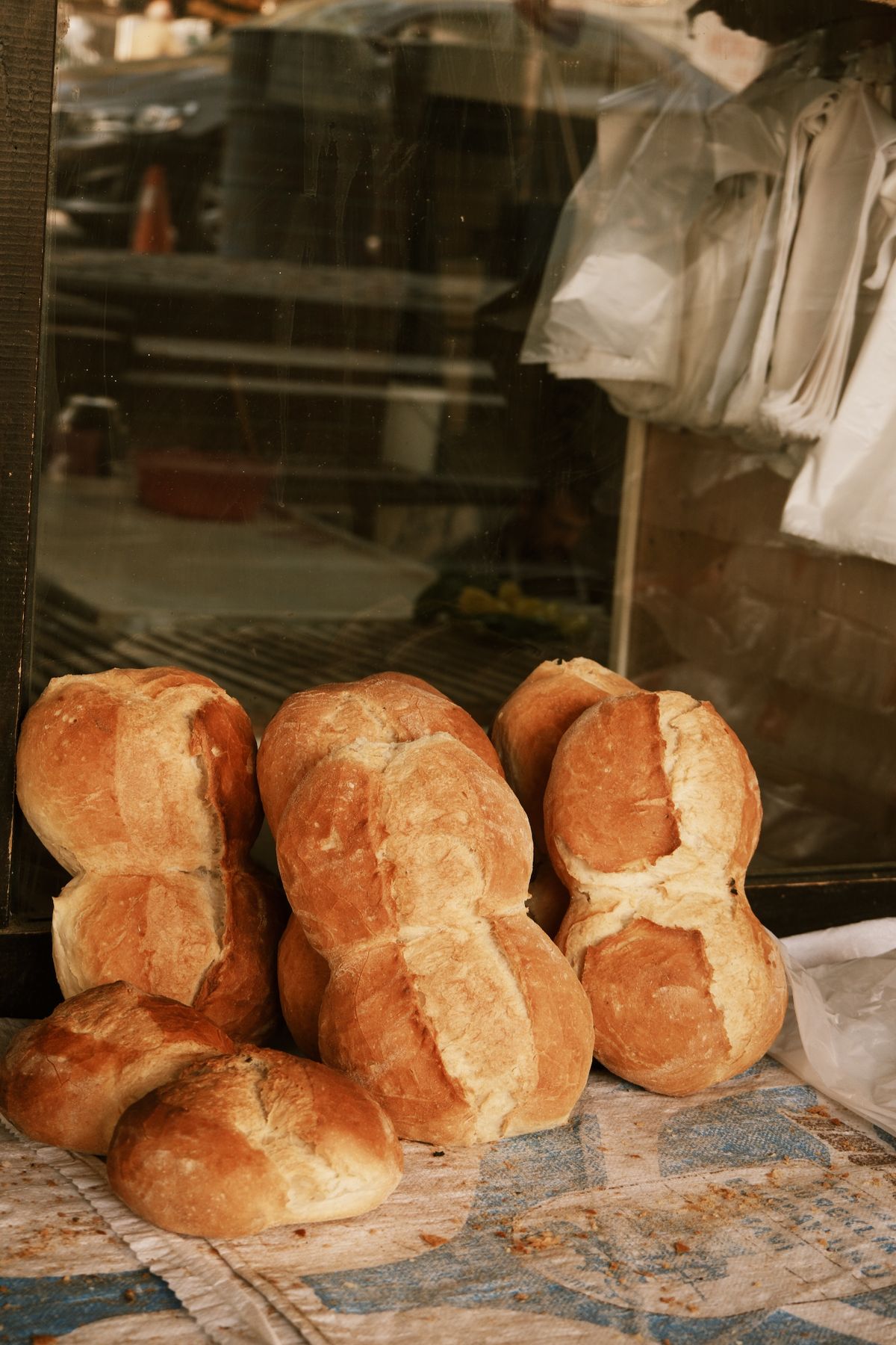Rustic loaves stacked in a bakery window