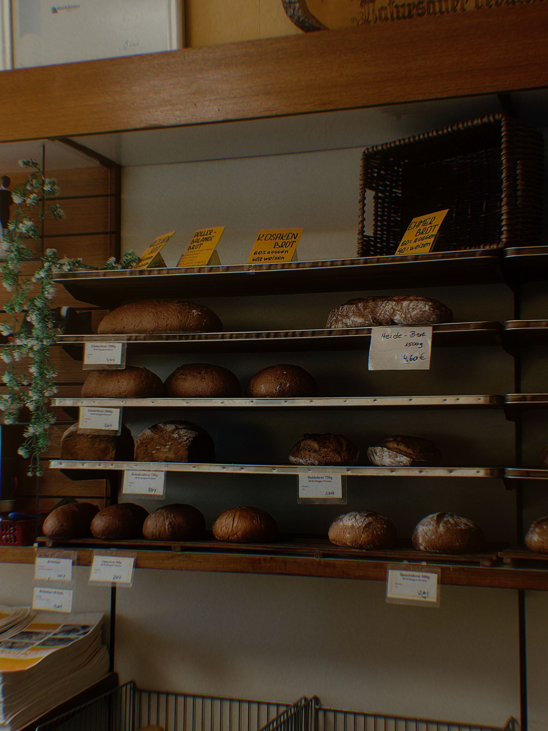Shelves of freshly baked loaves in a warm bakery