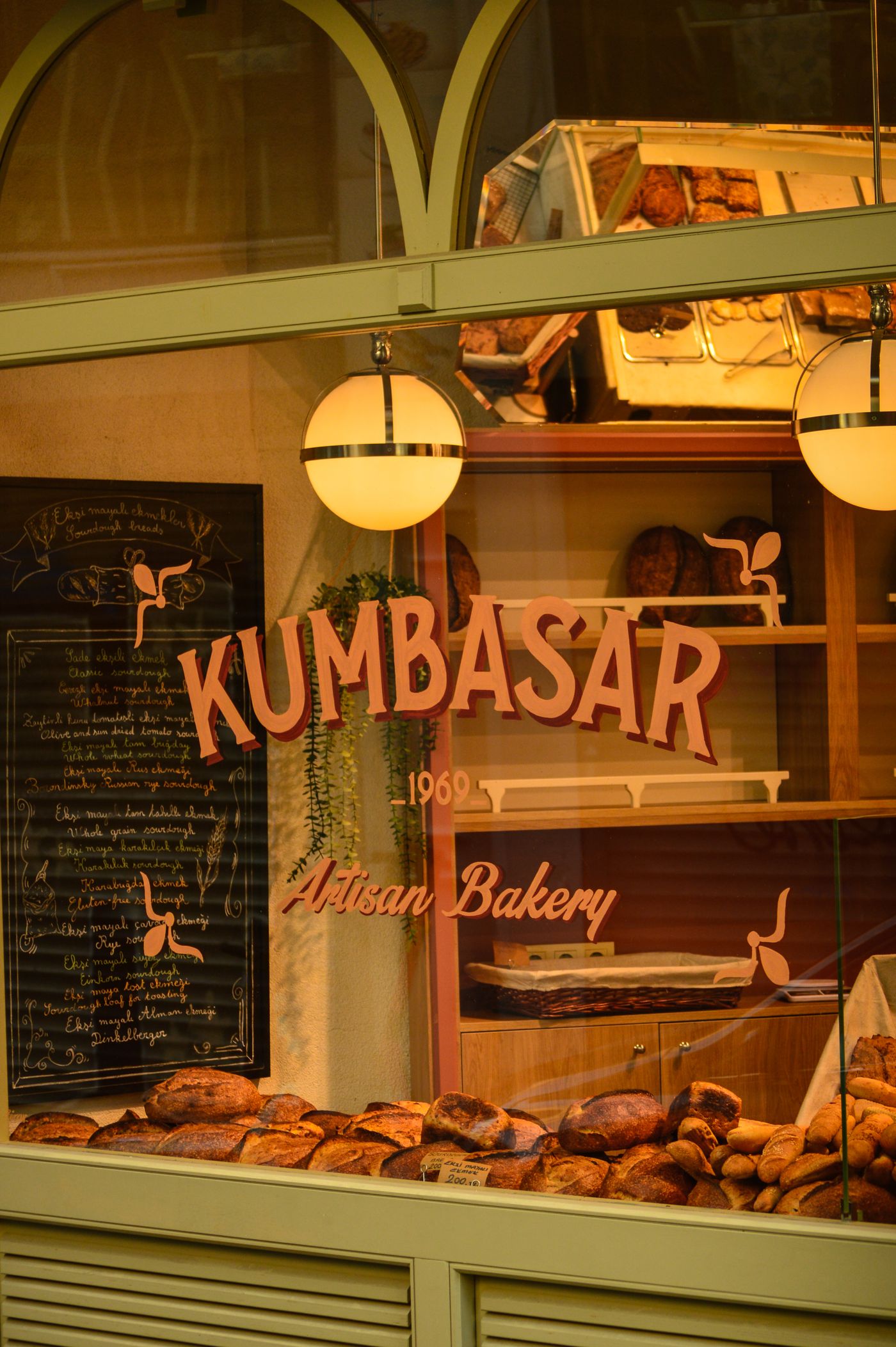 The bakery window from the street, loaves on display